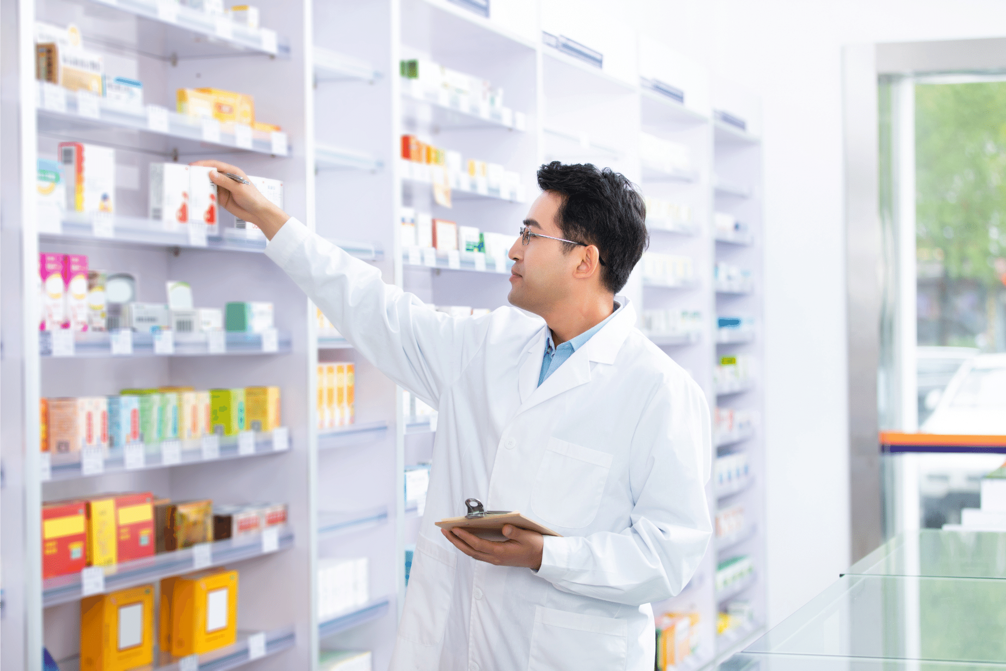 Pharmacist Looking at his Drug Inventory